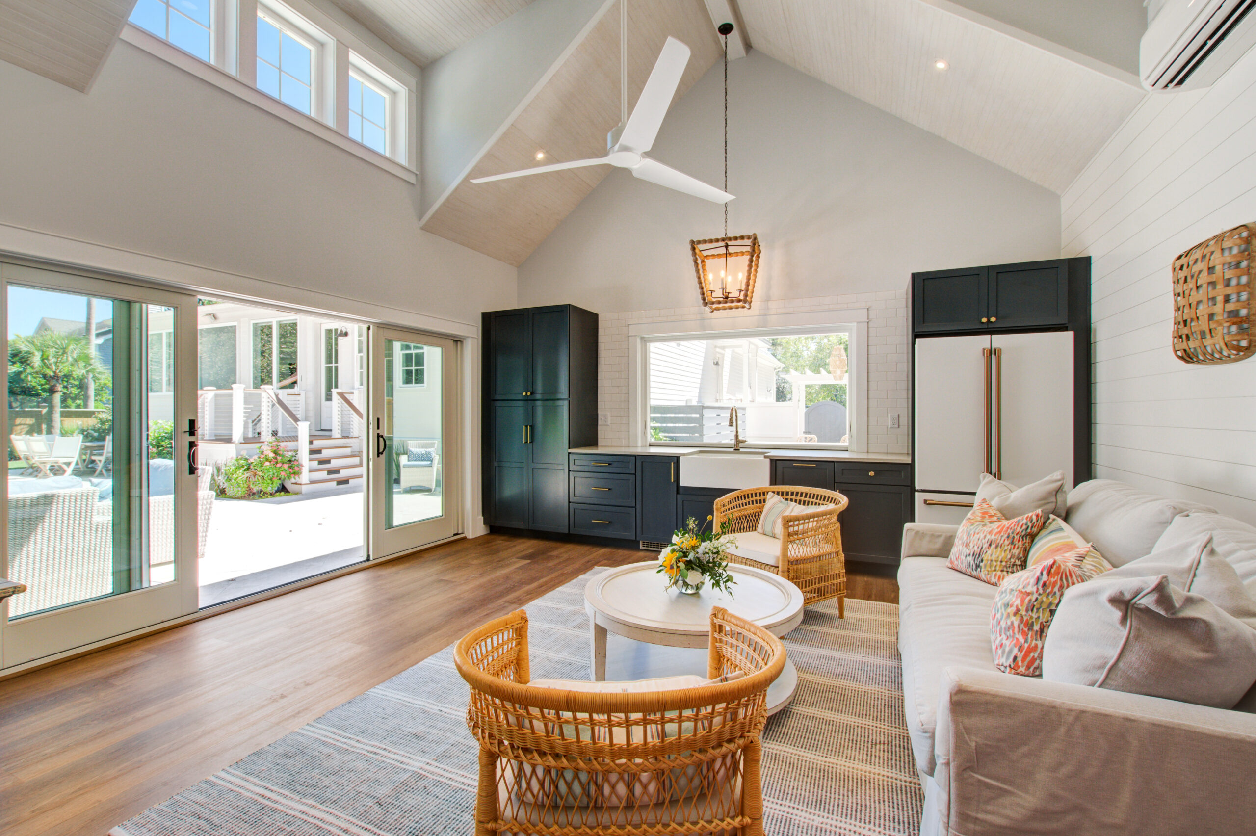 Living Space with vaulted ceilings, skyline windows, sliding glass doors, and wood floors allows for indoor - outdoor living -- Ck Contracting - Custom Home Renovations -- Mount Pleasant, SC.